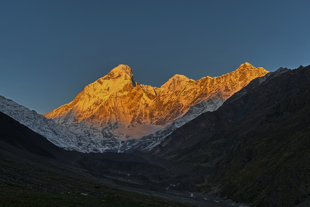 The morning sun illuminates Nanda Devi peak as seen from Nanda Devi base camp, in the northern Indian Himalayan state of Uttarakhand, on Oct. 1, 2025. (AP Photo/Satish Sharma)