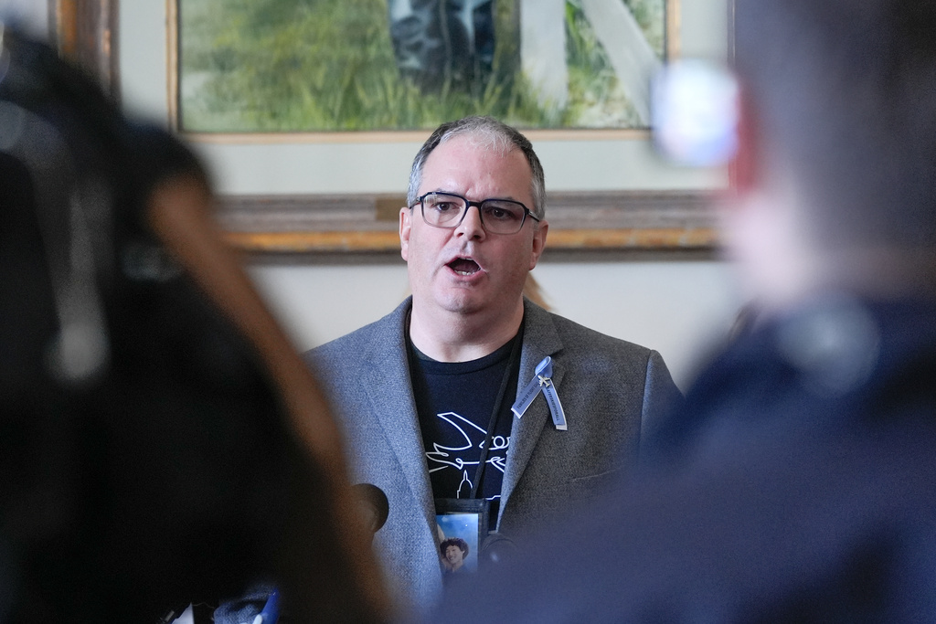 Doug Lane, a family member of those who were killed in the midair collision near Washington Reagan National Airport, speaks during a news conference on Capitol Hill, Tuesday, Feb. 24, 2026, in Washington. (AP Photo/Mariam Zuhaib)
