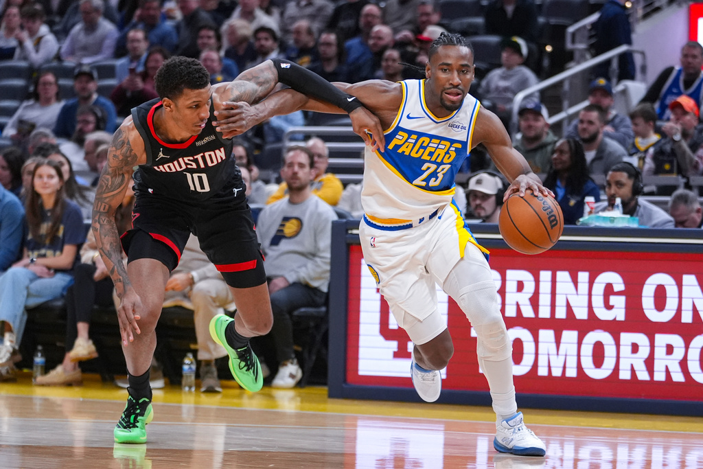 Indiana Pacers guard/forward Aaron Nesmith (23) drives on Houston Rockets forward Jabari Smith Jr. (10) during the first half of an NBA basketball game in Indianapolis, Monday, Feb. 2, 2026. (AP Photo/Michael Conroy)