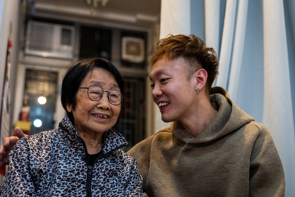 Pearl Chow, left, and Dorz Cheung, residents displaced by the deadly Wang Fuk Court fire speak during the interview at the transitional housing provided by the government in Hong Kong, Monday, Feb. 2, 2026. (AP Photo/Chan Long Hei)