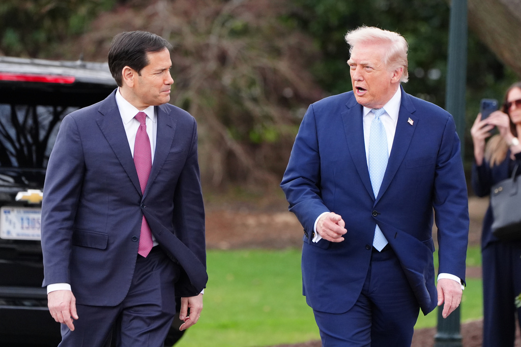 President Donald Trump walks with Secretary of State Marco Rubio before departing on Marine One from the South Lawn of the White House, Friday, March 20, 2026, in Washington. (AP Photo/Alex Brandon)