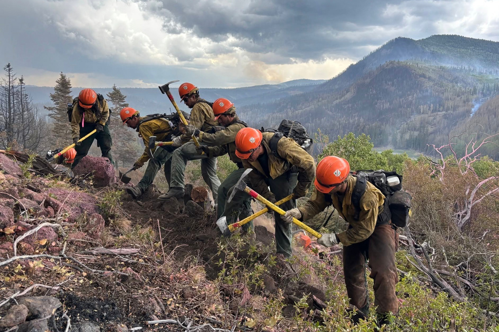 This image provided by the U.S. Forest Service Friday, June 26, 2026, shows firefighters responding to the Cottonwood Fire on Wednesday, June 24, 2026, above Birch Lake, near Beaver, Utah. (Mike McMillan/U.S. Forest Service via AP)