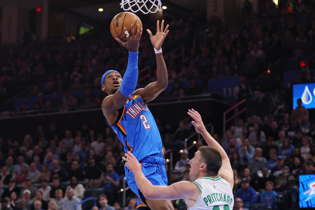 Oklahoma City Thunder guard Shai Gilgeous-Alexander (2) goes to the basket against Boston Celtics guard Payton Pritchard during the first half of an NBA basketball game, Thursday, March 12, 2026, in Oklahoma City. (AP Photo/Nate Billings)