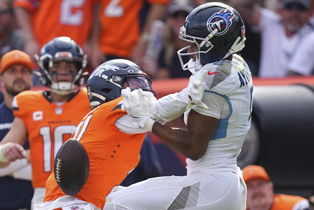 Denver Broncos cornerback Riley Moss breaks up a pass intended for Tennessee Titans wide receiver Elic Ayomanor, right during the second half of an NFL football game Sunday, Sept. 7, 2025, in Denver. (AP Photo/David Zalubowski)