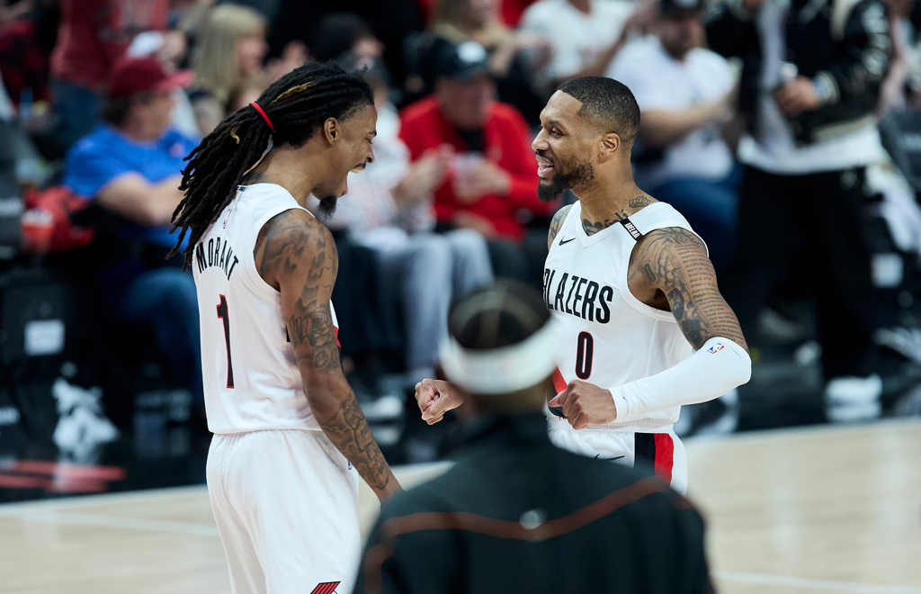 Portland Trail Blazers guard Damian Lillard, right, and guard Ja Morant celebrate after a basket against the Phoenix Suns during the second half of an NBA basketball game in Portland, Ore., Wednesday, Oct. 21, 2026. (AP Photo/Craig Mitchelldyer)
