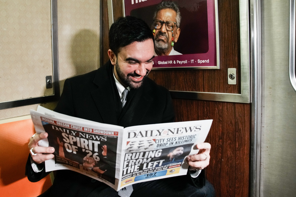 New York City Mayor Zohran Mamdani reads a newspaper on the subway on his way to City Hall in New York, Friday, Jan. 2, 2026. (AP Photo/Eduardo Munoz Alvarez)