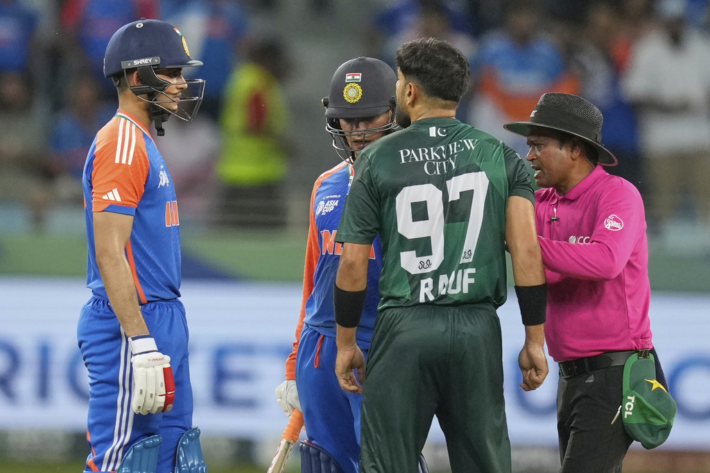 Umpire mediates between Indian players Abhishek Sharma, Shubman Gill and Haris Rauf during the Asia Cup cricket match between India and Pakistan at Dubai International Cricket Stadium, United Arab Emirates, Sunday, Sept. 21, 2025. (AP Photo/Altaf Qadri)