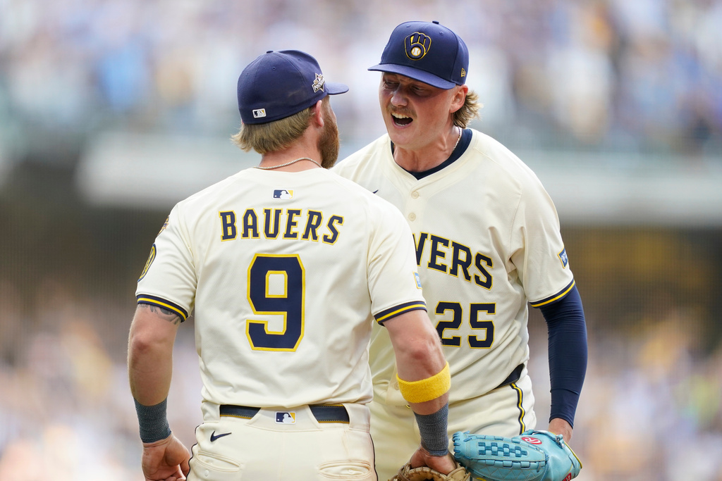 Milwaukee Brewers pitcher Nick Mears (25) celebrates with Jake Bauers (9) after defeating the Chicago Cubs 9-3 in Game 1 of baseball's National League Division Series, Saturday, Oct. 4, 2025, in Milwaukee. (AP Photo/Kayla Wolf)