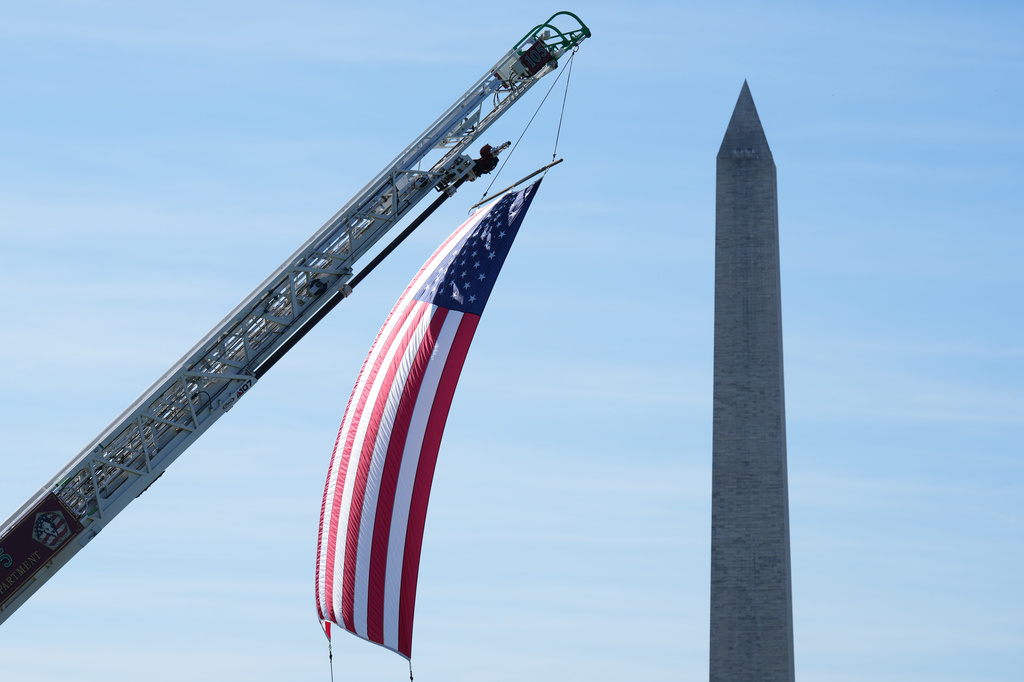 The U.S. flag is displayed during the Tunnel to Towers Foundation event for the 25th Anniversary of 9/11, on the Ellipse near the Washington monument, rear, in Washington, Tuesday, Sept. 8, 2026. (AP Photo/Jacquelyn Martin)