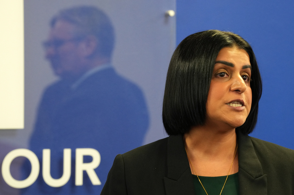FILE - Britain's Prime Minister Keir Starmer, left, is reflected as Britain's Home Secretary Shabana Mahmood speaks to members of the Jewish community at the Community Security Trust (CST) in north west London, Thursday, Oct. 16, 2025. (Carlos Jasso, Pool Photo via AP, file)