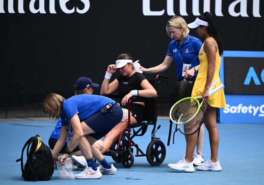 Marina Stakusic, center, of Canada is taken from the court in a wheelchair after retiring in her first round match against Priscilla Hon, right, of Australia at the Australian Open tennis tournament in Melbourne, Australia, Monday, Jan. 19, 2026. (Joel Carrett/AAP Image via AP)