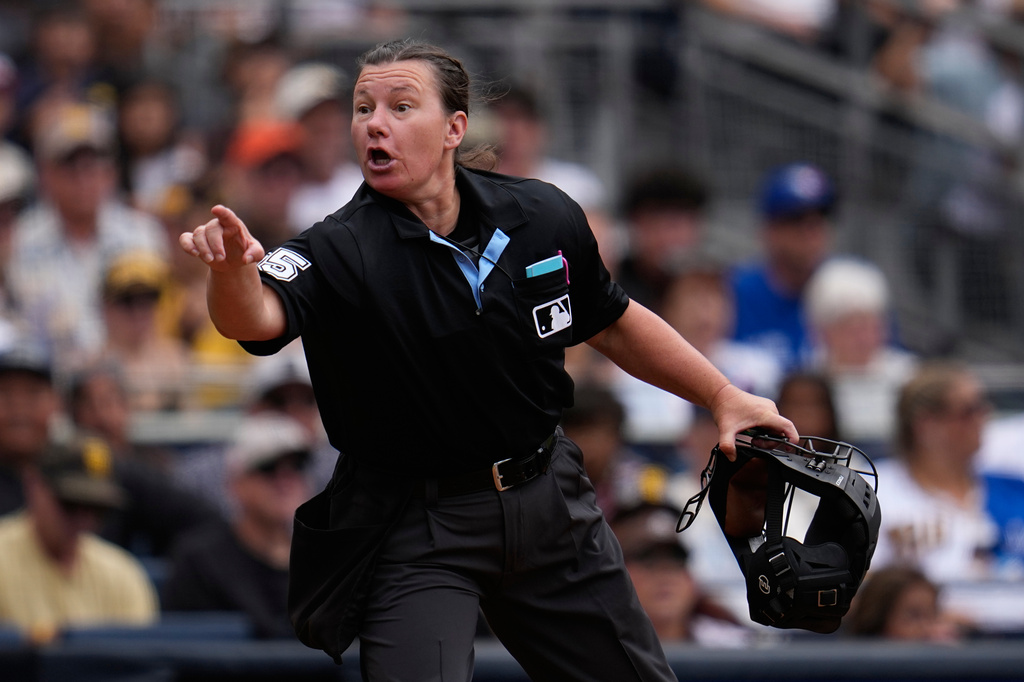 Home plate umpire Jen Pawol (95) gestures towards the San Diego Padres dugout after hitting coach Steven Souza Jr. was ejected during the second inning of a baseball game against the Toronto Blue Jays Sunday, July 12, 2026, in San Diego. (AP Photo/Gregory Bull)