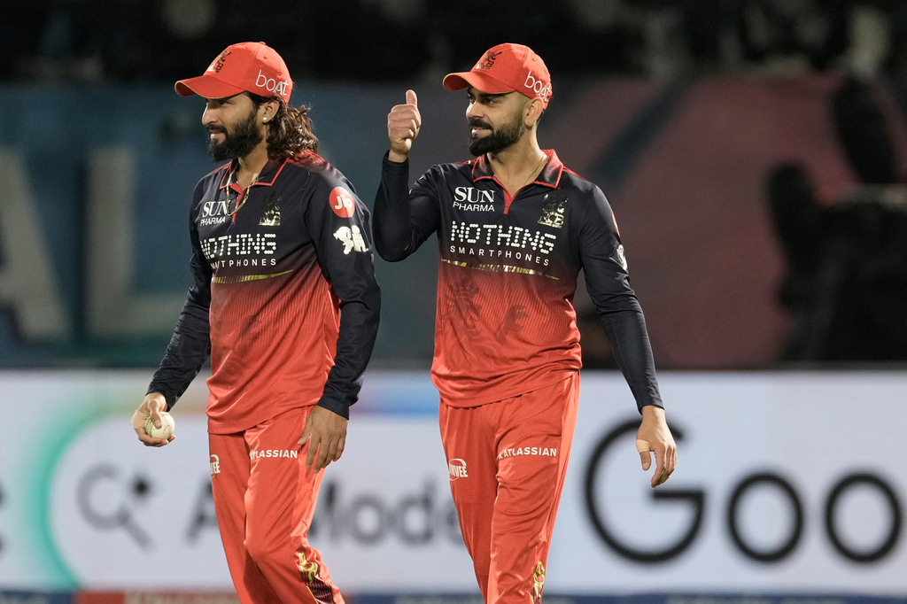 Royal Challengers Bengaluru's captain Rajat Patidar, left, celebrates with teammate Virat Kohli after taking the catch to dismiss Gujarat Titans' Rahul Tewatia during the Indian Premier League cricket match between Gujarat Titans and Royal Challengers Bengaluru in Dharamshala, India, Tuesday, May 26, 2026. (AP Photo/Ashwini Bhatia)