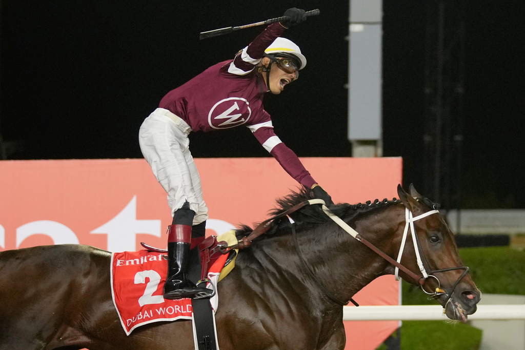Jockey Jose Ortiz, aboard Magnitude, celebrates winning the $12 million Dubai World Cup horse race over 2000m (10 furlongs) at Meydan Racecourse in Dubai, the United Arab Emirates, Saturday, March 28, 2026. (AP Photo/Altaf Qadri)
