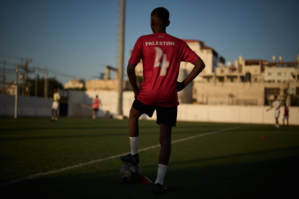 Wearing a Palestinian national team soccer jersey, a youth from a local academy takes part in a training session at Jamal Ghanem Stadium in the West Bank city of Tulkarem, Thursday, June 4, 2026. (AP Photo/Leo Correa)