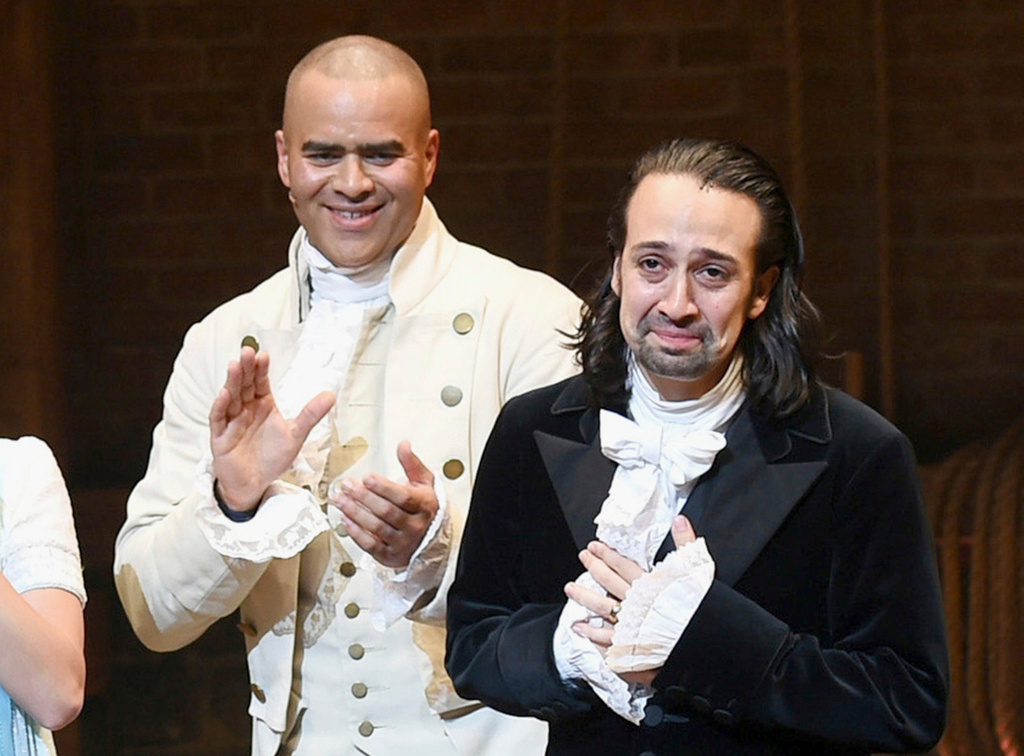 FILE - Lin-Manuel Miranda, right, takes his final performance curtain call with cast member Christopher Jackson after a performance of "Hamilton" in New York on July 9, 2016. (Photo by Evan Agostini/Invision/AP, File)