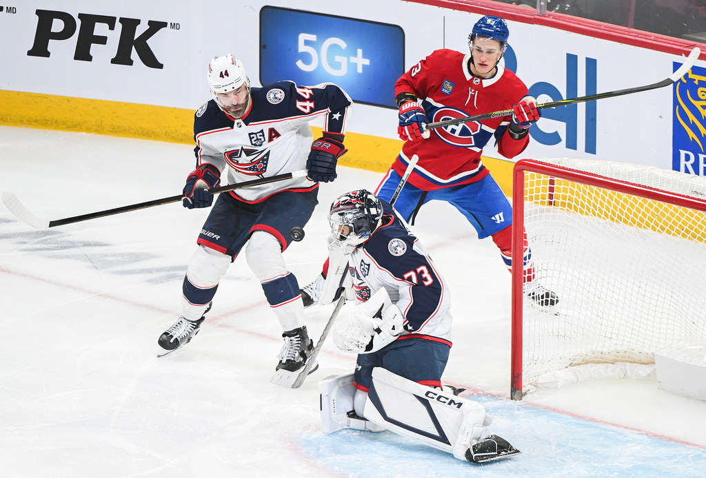 Columbus Blue Jackets goaltender Jet Greaves (73) makes a save as Blue Jackets' Erik Gudbranson (44) defends against Montreal Canadiens' Ivan Demidov (93) during the second period of an NHL hockey game in Montreal, Thursday, March 26, 2026. (Graham Hughes/The Canadian Press via AP)