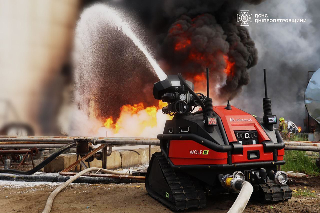 In this photo provided by the Ukrainian Emergency Service, emergency services personnel work to extinguish a fire following a Russian drone attack on a gas pipeline in Dnipropetrovsk region, Ukraine, Wednesday, May 13, 2026. (Ukrainian Emergency Service via AP)