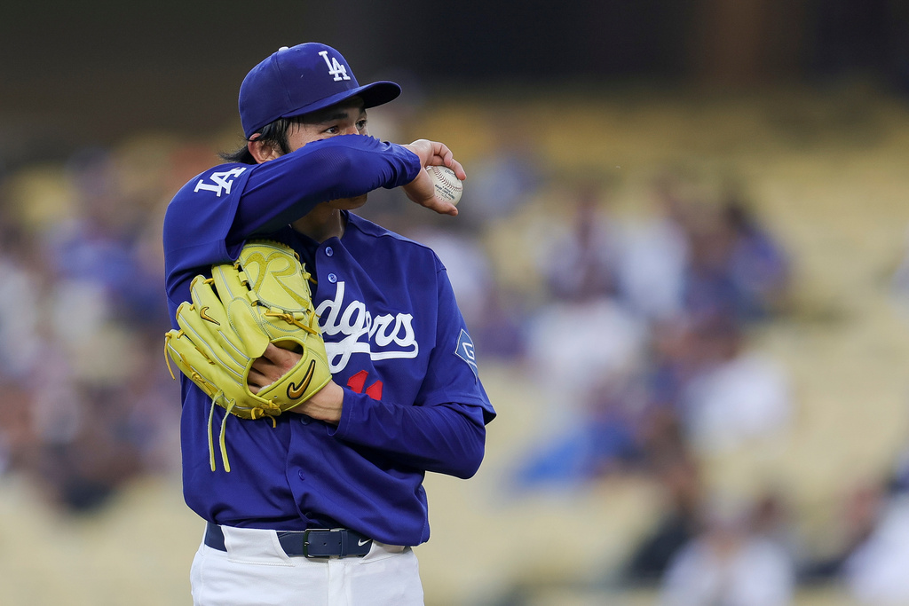 Los Angeles Dodgers starting pitcher Roki Sasaki reacts during the first inning of a spring training baseball game against the Los Angeles Angels, Monday, March 23, 2026, in Los Angeles. (AP Photo/Ryan Sun)