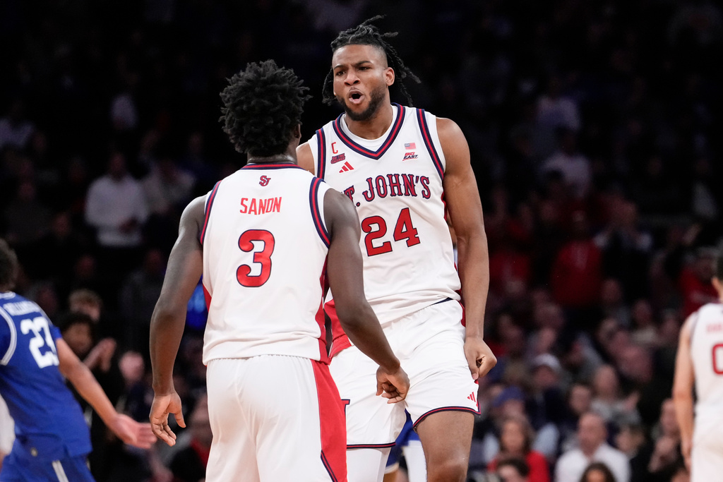 St. John's forward Zuby Ejiofor (24) yells at St. John's guard Joson Sanon (3) during the second half of an NCAA college basketball game against Seton Hall in the semifinals of the Big East tournament, Friday, March 13, 2026, in New York. (AP Photo/Yuki Iwamura)