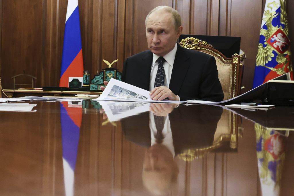 Russian President Vladimir Putin listens to Vladimir Saldo, the Moscow-appointed head of the Russian-controlled Kherson region of Ukraine, during their meeting at the Kremlin in Moscow, Russia, on Tuesday, Aug. 26, 2025. (Vyacheslav Prokofyev, Sputnik, Kremlin Pool Photo via AP)