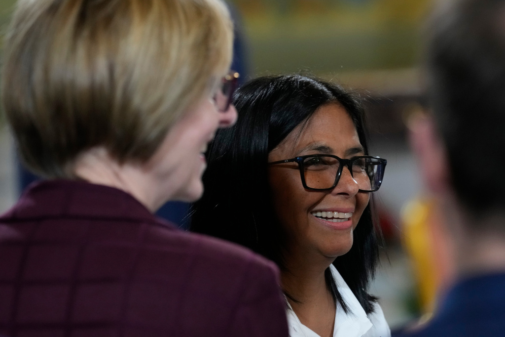 Acting President Delcy Rodriguez smiles, next to U.S. Charge D'affaires Laura Dogu, after signing an agreement to allow Chevron to expand its oil operations in Venezuela, at Miraflores presidential palace in Caracas, Venezuela, Monday, April 13, 2026. (AP Photo/Ariana Cubillos)