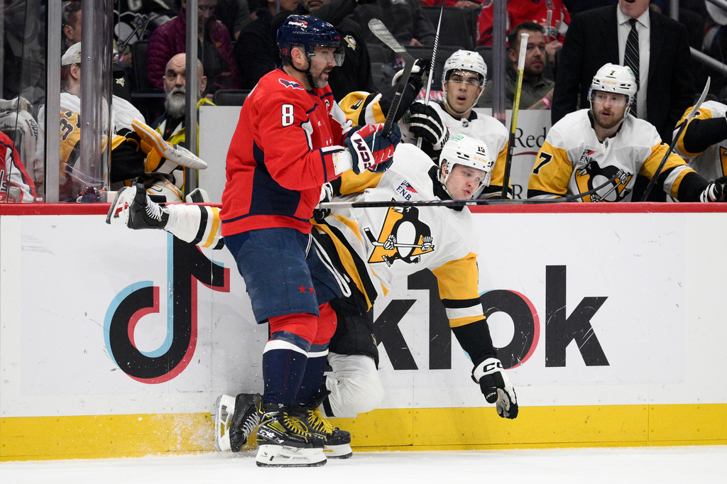 Washington Capitals left wing Alex Ovechkin (8) hits Pittsburgh Penguins left wing Joona Koppanen, right, during the first period of an NHL hockey game, Sunday, April 12, 2026, in Washington. (AP Photo/Nick Wass)