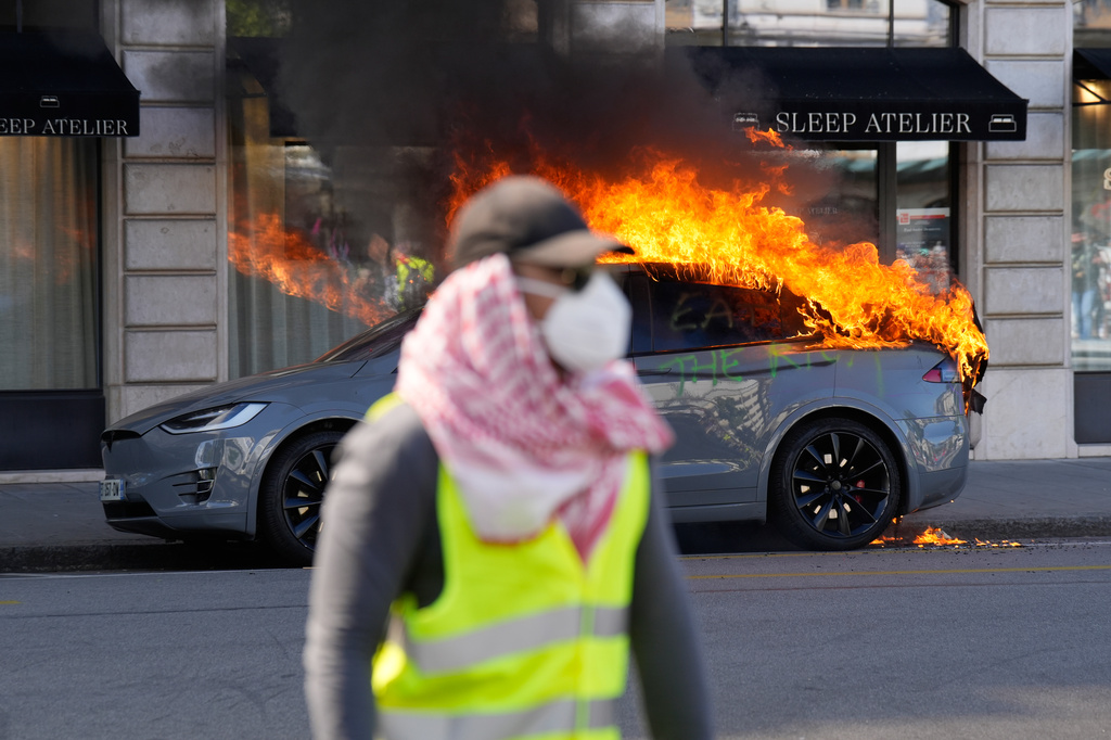 A car burns during a "No G7" demonstration in Geneva, Switzerland, Sunday, June 14, 2026, ahead of the G7 summit scheduled to take place June 15-17. (AP Photo/Baz Ratner)