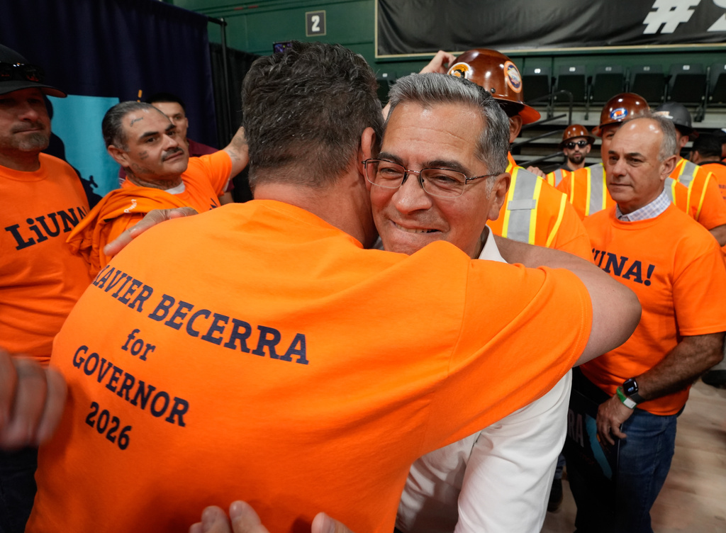 California gubernatorial candidate,Xavier Becerra, D-CA, is hugged by a supporter from the Labor International Union of North America, at a town hall meeting in Sacramento, Calif., Monday, May 11, 2026. (AP Photo/Rich Pedroncelli)