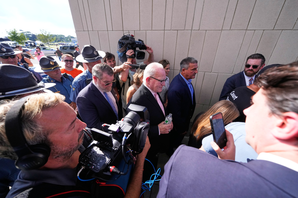 Defense attorney Kevin Reddington, center, leaves court, flanked by media and law enforcement, after the judge declared a mistrial in Lindsay Clancy's murder trial at Plymouth County Superior Court, Friday, Sept. 4, 2026, in Plymouth, Mass. (AP Photo/Charles Krupa)
