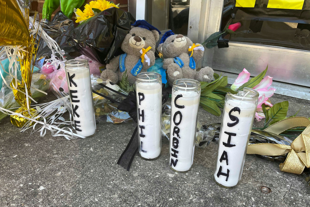 FILE - Candles with the names of the four young people killed in a shooting sit outside the Mahogany Masterpiece dance studio on April 19, 2023, in Dadeville, Ala. (AP Photo/Kimberly Chandler, File)