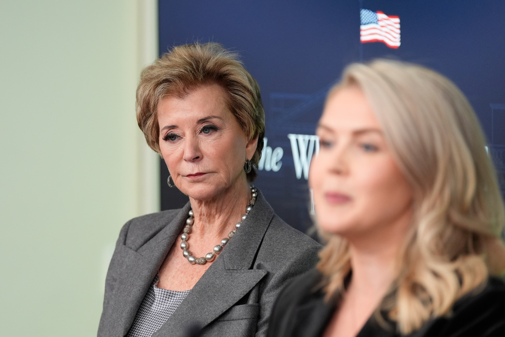 Education Secretary Linda McMahon, left, looks on as White House press secretary Karoline Leavitt speaks with reporters in the James Brady Press Briefing Room at the White House, Thursday, Nov. 20, 2025, in Washington. (AP Photo/Alex Brandon)