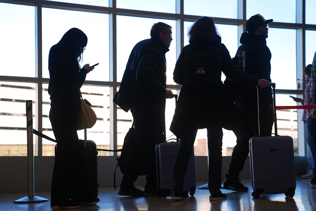 Travelers wait in a security check point line at Philadelphia International Airport, Tuesday, March 24, 2026, in Philadelphia. (AP Photo/Matt Rourke)