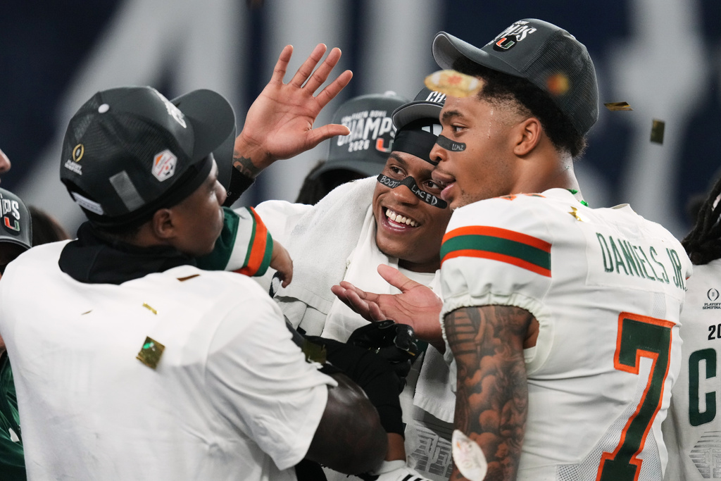 Miami players celebrate after winning the Fiesta Bowl NCAA college football playoff semifinal game against Mississippi, Thursday, Jan. 8, 2026, in Glendale, Ariz. (AP Photo/Ross D. Franklin)