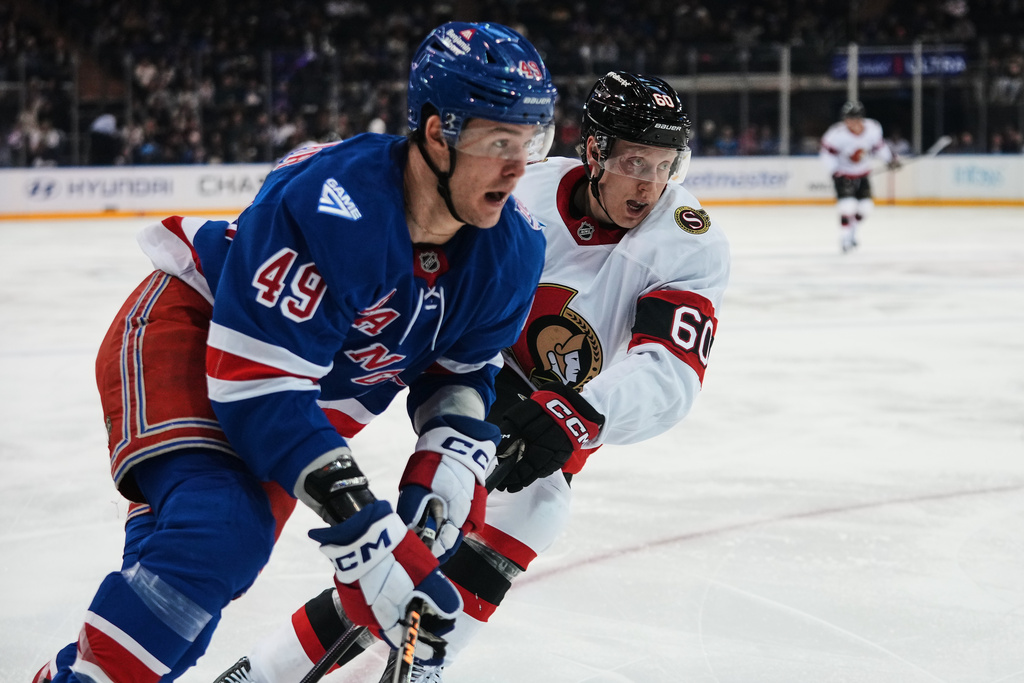 Ottawa Senators' Lassi Thomson (60) defends New York Rangers' Jaroslav Chmelar (49) during the second period of an NHL hockey game Monday, March 23, 2026, in New York. (AP Photo/Frank Franklin II)