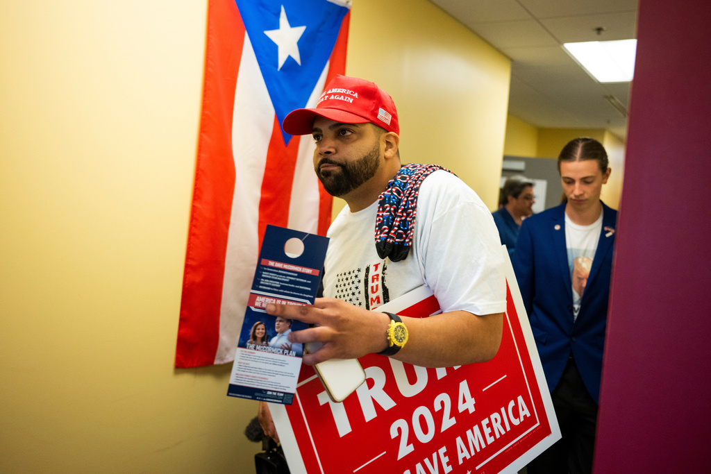 FILE - Juan Ojeda, 33, who is Puerto Rican, attends a grand opening event at the "Latino Americans for Trump" office in Reading, Pa., June 12, 2024. (AP Photo/Joe Lamberti, FIle)