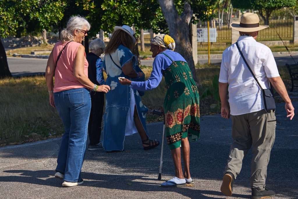An elderly woman begs for alms from tourists in Havana, Cuba, Thursday, Feb. 26, 2026. (AP Photo/Ramon Espinosa)