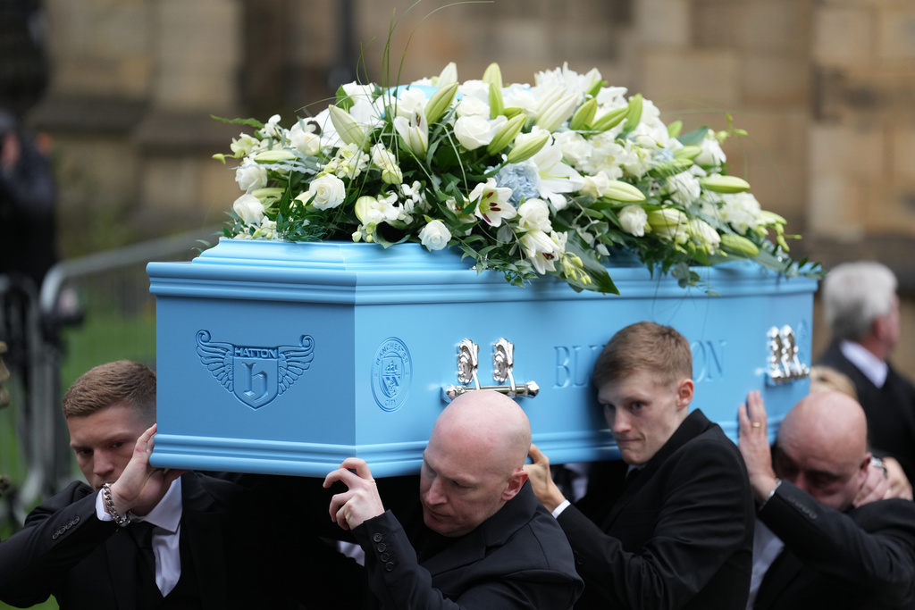 Family members carry the coffin of boxer Ricky Hatton out of Manchester Cathedral following his funeral in Manchester, England, Friday, Oct. 10, 2025. (AP Photo/Jon Super)
