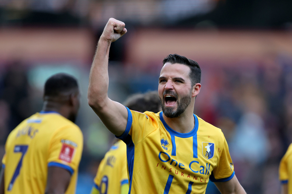 Mansfield Town's Stephen McLaughlin celebrates scoring during the English FA Cup fourth round soccer match between Burnley and Mansfield Town in Burnley, England, Saturday Feb. 14, 2026. (Richard Sellers/PA via AP)