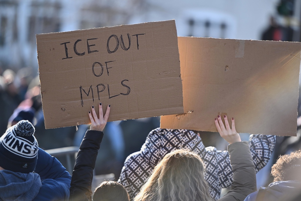 Protesters gather near the scene of the fatal shooting involving federal law enforcement agents, Wednesday, Jan. 7, 2026, in Minneapolis. (AP Photo/Tom Baker)