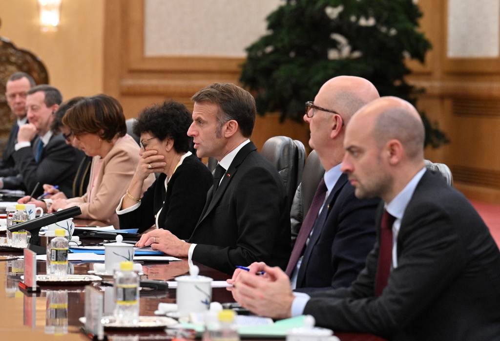 France's President Emmanuel Macron, center, speaks to China's President Xi Jinping, unseen, during a bilateral meeting at the Great Hall of the People in Beijing, Thursday, Dec. 4, 2025. (Adek Berry/Pool Photo via AP)