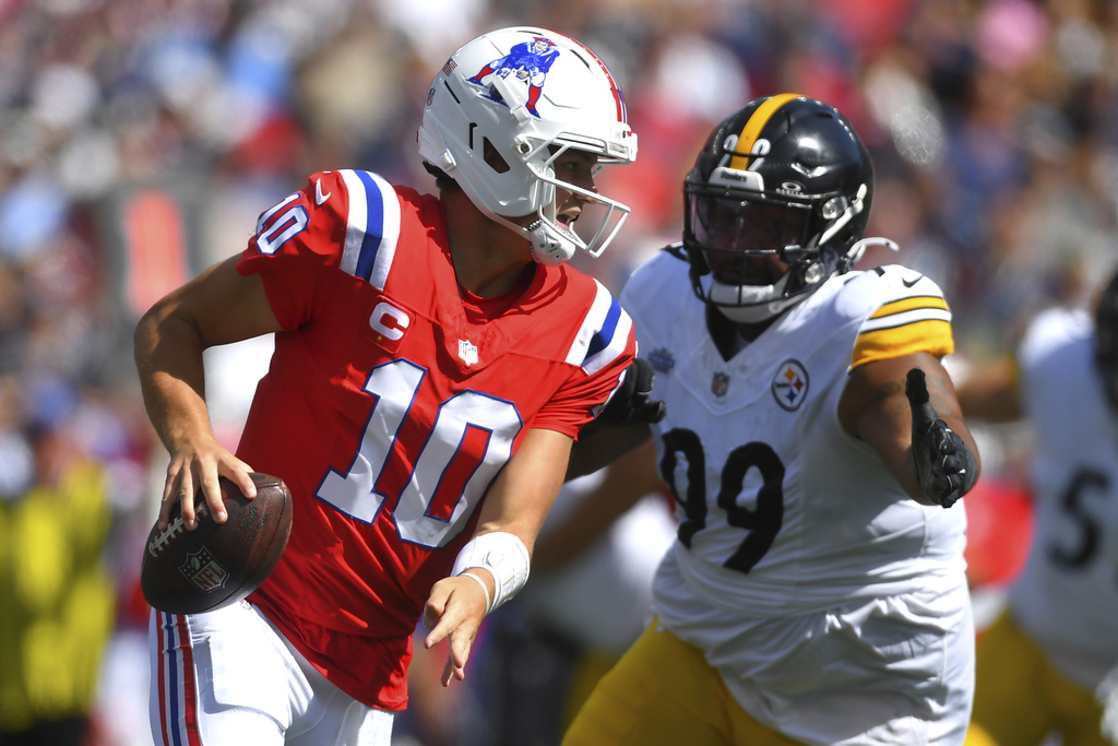New England Patriots quarterback Drake Maye (10) runs against Pittsburgh Steelers defensive tackle Derrick Harmon (99) during the first half of an NFL football game, Sunday, Sept. 21, 2025, in Foxborough, Mass. (AP Photo/Steven Senne)