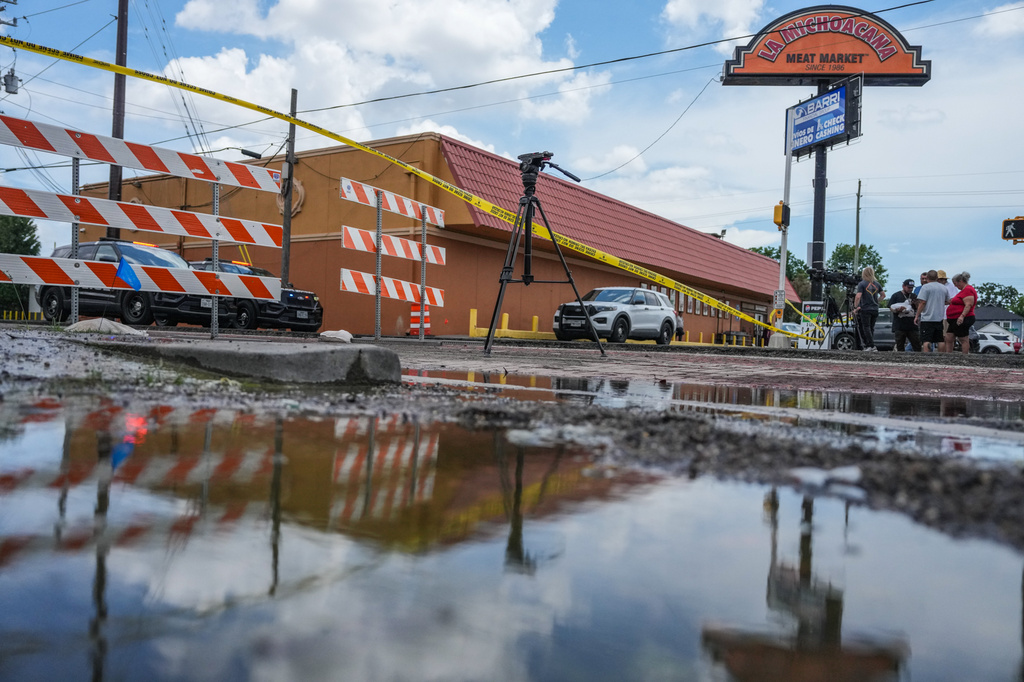 Police work on Canal Street in Houston, Tuesday, July 7, 2026, after a shooting. (Jacob Lujan/Houston Chronicle via AP)
