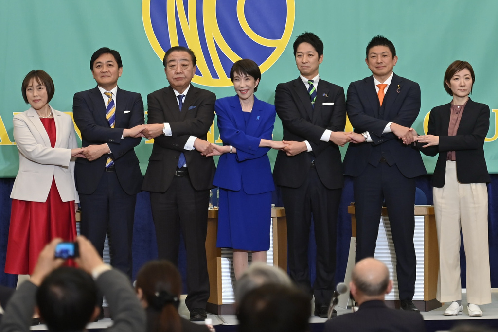 FILE - Leaders of Japan's ruling and opposition parties pose for a photo during a debate at the Japan National Press Club before the election in Tokyo, Jan. 26, 2026. From left are Communist Party Chair Tomoko Tamura, Democratic Party for the People leader Yuichiro Tamaki, Centrist Reform Alliance co-leader Yoshihiko Noda, Liberal Democratic Party President and Prime Minister Sanae Takaichi, Japan Innovation Party co-leader Fumitake Fujita, Sanseito leader Sohei Kamiya and Reiwa Shinsengumi co-leader Akiko Oishi (David Mareuil/Pool Photo via AP, File)