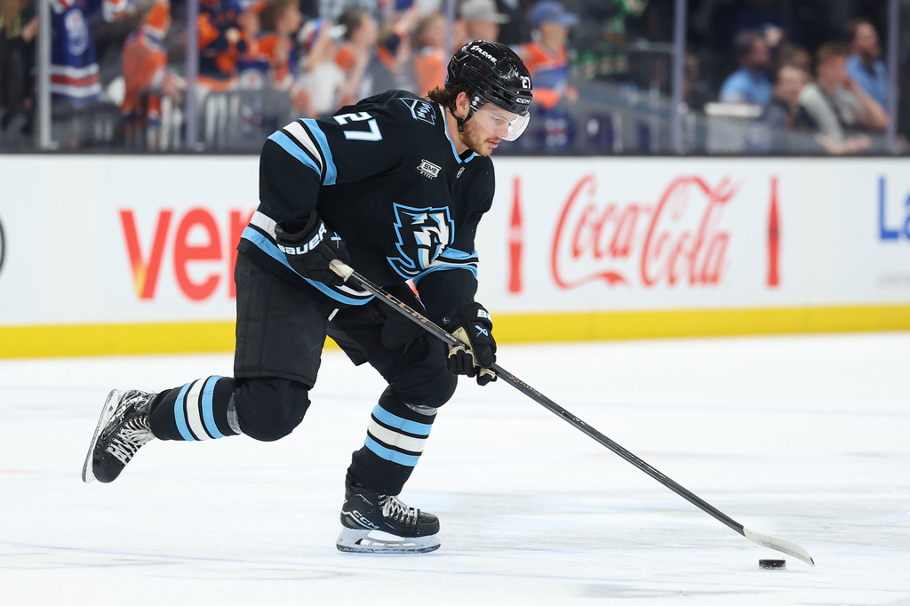 FILE - Utah Mammoth center Barrett Hayton (27) skates with the puck during warmups before an NHL hockey game against the Edmonton Oilers, March 24, 2026, in Salt Lake City. (AP Photo/Melissa Majchrzak, File)