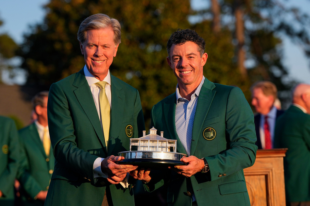 Augusta National Golf Club chairman Fred Ridley, left, and Rory McIlroy, of Northern Ireland, hold the trophy after the Masters golf tournament at the Augusta National Golf Club, Sunday, April 12, 2026, in Augusta, Ga.( (AP Photo/David J. Phillip)
