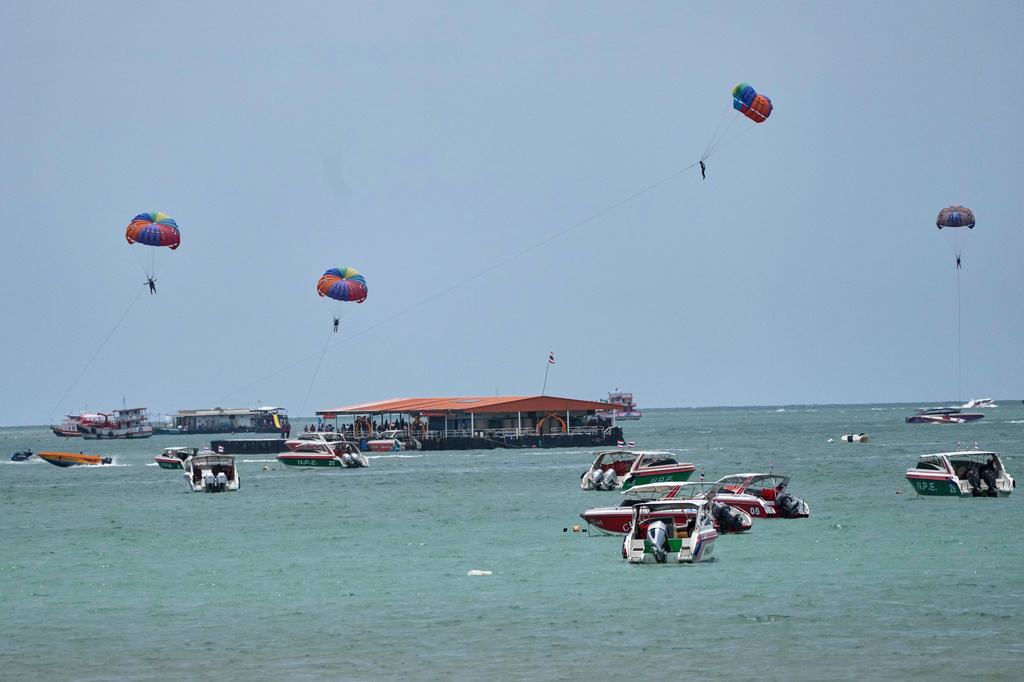 Tourists parasail on Pattaya Beach in Thailand, on Aug. 31, 2026. (AP Photo/Sakchai Lalit)