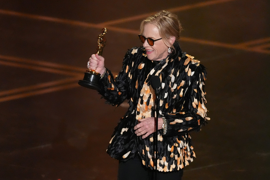Amy Madigan accepts the award for actress in a supporting role for "Weapons" during the Oscars on Sunday, March 15, 2026, at the Dolby Theatre in Los Angeles. (AP Photo/Chris Pizzello)