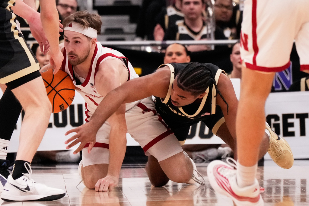Nebraska guard Sam Hoiberg, left, battles for a the ball against Purdue guard C.J. Cox, right, during the first half of an NCAA college basketball game in the quarterfinals of the Big 10 Conference tournament, Friday, March 13, 2026, in Chicago. (AP Photo/Nam Y. Huh)