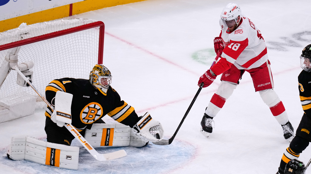 Boston Bruins goaltender Jeremy Swayman (1) makes a glove save against Detroit Red Wings center Andrew Copp (18) during the first period of an NHL hockey game, Tuesday, Jan. 13, 2026, in Boston. (AP Photo/Charles Krupa)